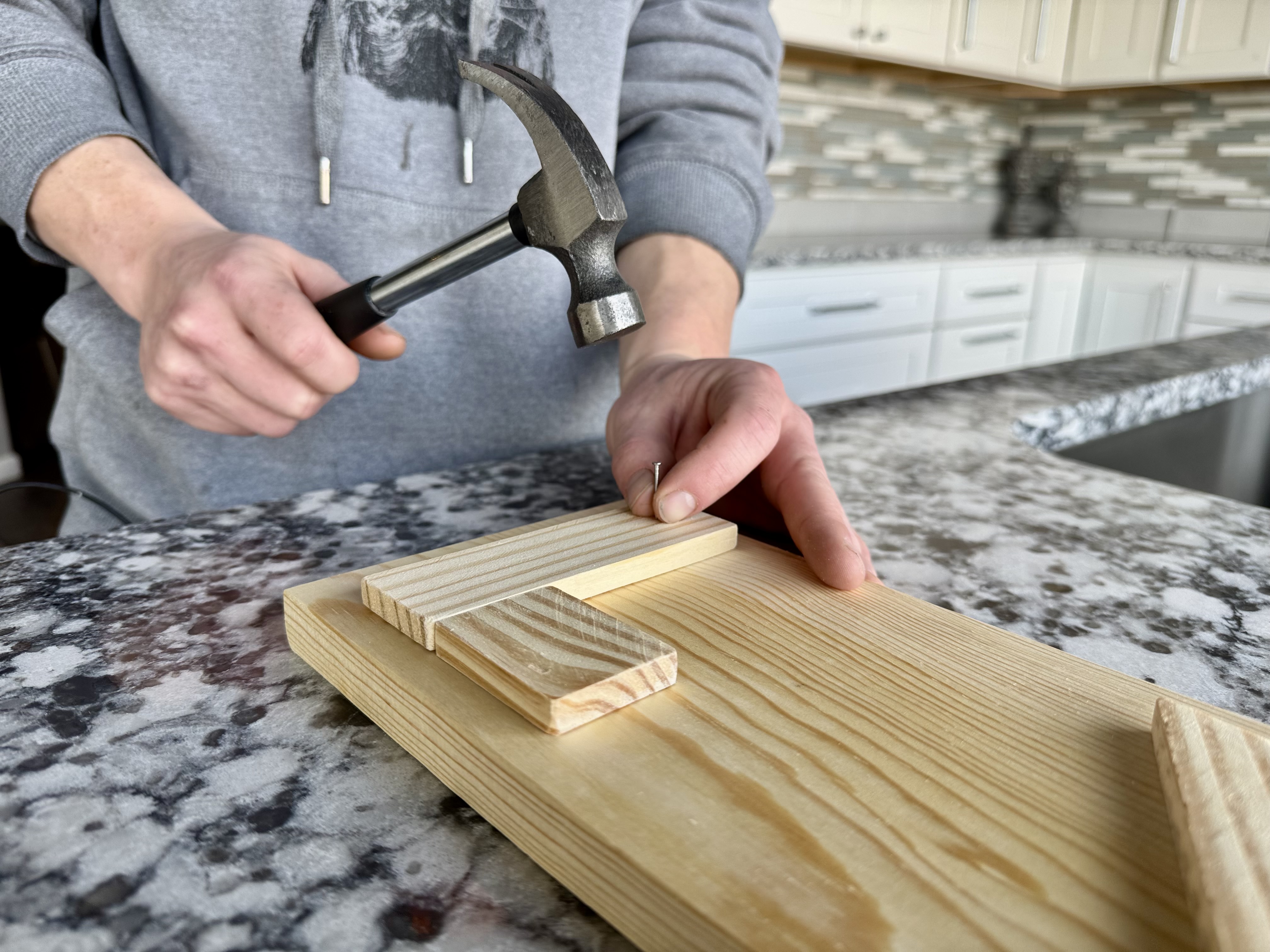 Place a nail in each marked spot from Step 3. Hold it steady while a grown up helps tap it in straight.